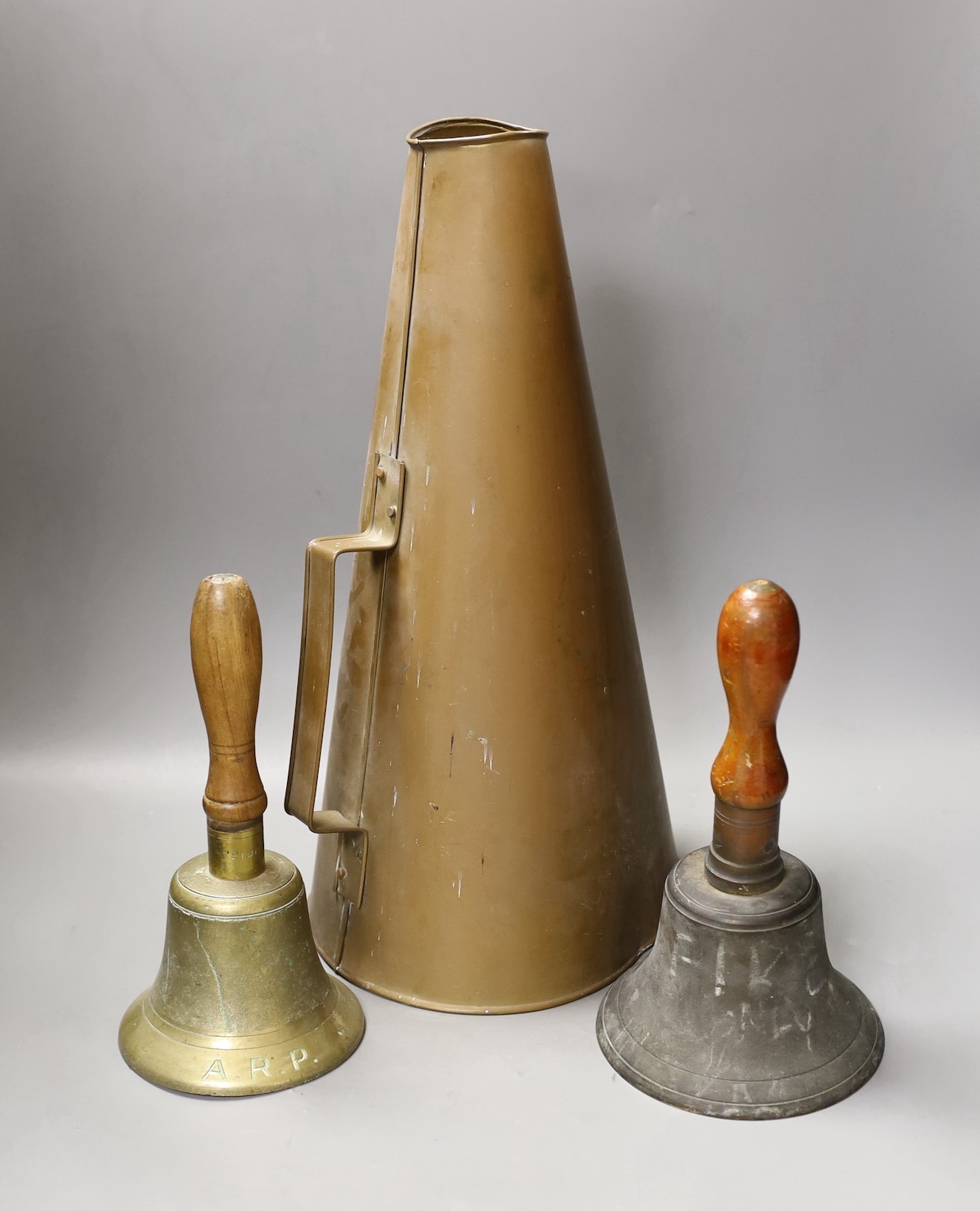 Two World War Two hand-bells, 26cm, and a brass wartime loud-haler